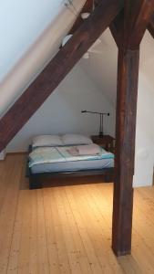 a bed in a room with a wooden floor at Ferienwohnung Katrin in Mettlach