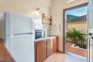 a kitchen with a refrigerator and a balcony at Castellos Bellos Studio 2 in Marathias +19 photos