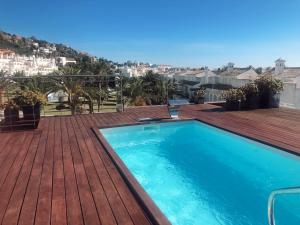 a swimming pool on top of a wooden deck at Hotel Atlántico in Zahara de los Atunes