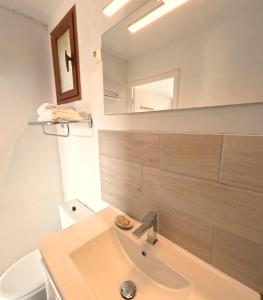 un baño con lavabo y espejo en Azur Hotel, en Le Lavandou