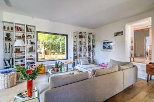a living room with a couch and a table at Large house with garden in Bougival - Welkeys in Bougival