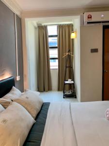 เตียงในห้องที่ Andiana Hotel & Lodge - Kota Bharu City Centre
