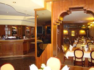 un ristorante con tavoli e sedie e un bar di Хотел-ресторант Астория a Pazardžik