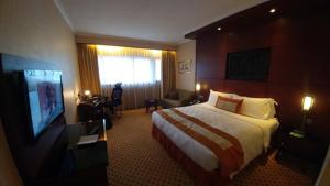 a hotel room with a bed and a television at Hotel Creastview Inn New Delhi At International Airport in New Delhi