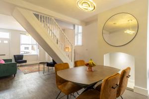 a dining room with a table and a mirror at Sparkenhoe House in Hugglescote +14 photos