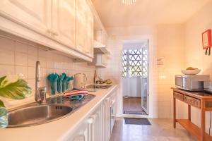 a kitchen with a sink and a counter top at Mi Capricho beach front sea view & pool - Happy Rentals in Mijas Costa