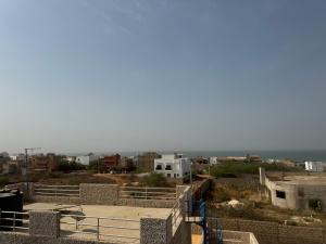 a view of the ocean from the roof of a building at Résidences Salsia - Toubab Dialaw - Appt RDC in Rufisque