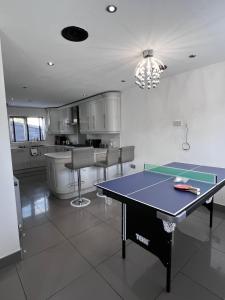 a kitchen with a ping pong table in it at The Grey Mansion in Manchester
