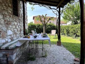 a table with plates of food on it in a patio at Casa Silvia in Lucca