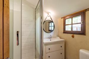 a bathroom with a sink and a mirror at Nature et authenticité in Saint-André-de-Double