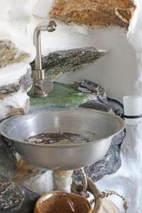 a metal sink with a faucet in a room at Artistic Cycladic House Ano Syros in Ermoupoli
