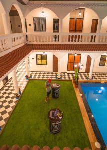 an overhead view of a man standing in front of a pool at Sapphire Mansion in Alibag