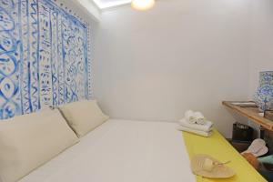 a room with a bed and a blue and white wall at Artistic Cycladic House Ano Syros in Ermoupoli