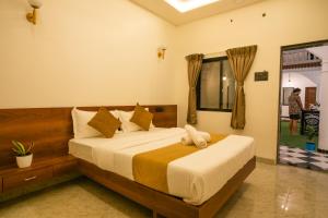 a bedroom with a large bed in a room at Sapphire Mansion in Alibag