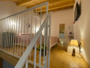 a bedroom with a bed and a staircase in a room at Residenza Ronna Razia in Avola