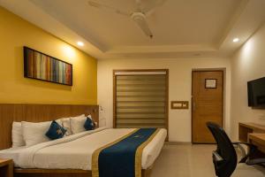 a hotel room with a bed and a television at Sparrow Hotels managed by Siara in Alwar