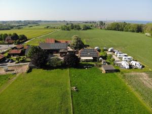 an aerial view of a farm with cars parked in a field at Ostseebauernhof Schönhagen in Brodersby