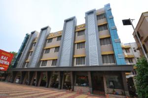 a row of buildings on a street at Hotel Yogiraj in Shirdi