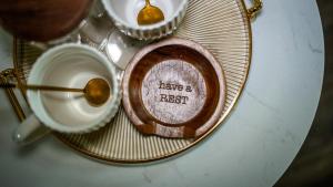 a plate withhave a rest written on it next to a cup of coffee at Howfield Hotel in Merthyr Tydfil
