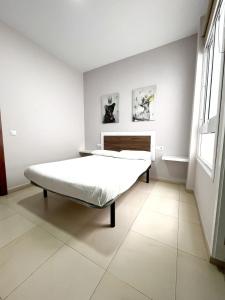 Habitación blanca con cama y ventana en Sunset Relax Apartment by Canary365, en Tenoya