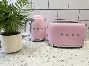 two toasters sitting on a counter next to a plant at The Mount Somerton Apartments - Somerset Private, Peaceful & 400 mtres from the village in Somerton