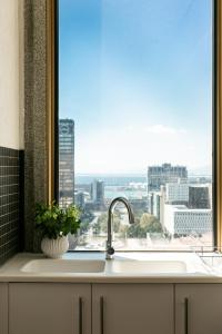 a kitchen sink with a window with a view of a city at #1905 Cartwright - The Spitfire in Cape Town