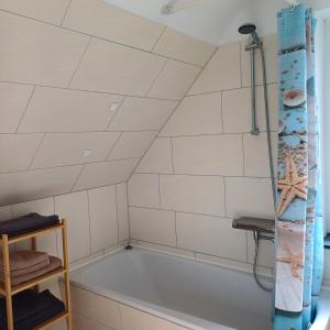 a bathroom with a tub and a shower at Ferienhaus mit 4 Schlafzimmer in Pansdorf +15 photos