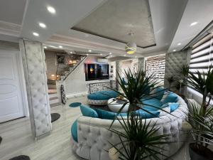 a living room with two couches and a tv at Villa By expert VIP in Sarajevo