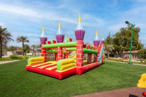 a colorful inflatable playground in a park at Flamingo Cottages in Manama