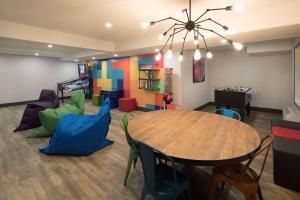 a play room with a table and chairs at Ramada by Wyndham Cochrane in Cochrane
