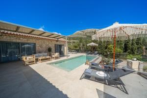a house with a swimming pool and a patio at Villa Fernando - F&A Golden Stone Villas in Loukáta