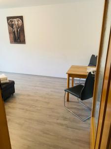 an office with a table and an elephant painting on the wall at Rhönluft in Wildflecken