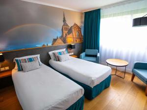 Katil atau katil-katil dalam bilik di Mercure Mont Saint Michel