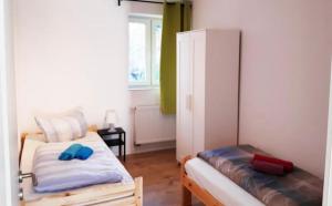 um pequeno quarto com 2 camas e uma janela em home2stay Worker Houses Wernau Kitchen,Wifi,Smart TV,Parking *** em Wernau