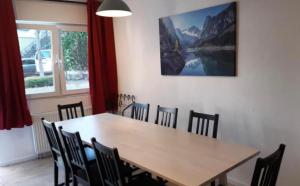 a dining room with a wooden table and chairs at home2stay Worker Houses Wernau Kitchen,Wifi,Smart TV,Parking *** in Wernau