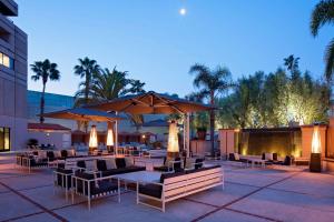 a patio with tables and chairs and umbrellas at Hyatt Regency Santa Clara in Santa Clara