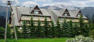 a house covered in plants in front of a mountain at SILVER Zawoja in Zawoja