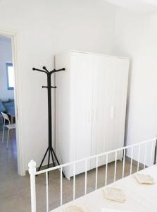 a white bedroom with a bed and a white closet at Aeriko Apartment in Paros in Dhragoulás