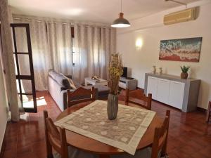 a living room with a table and a couch at T2 Alvor Terrace in Alvor