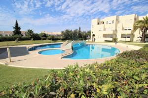 a large swimming pool in front of a building at T2 Alvor Terrace in Alvor