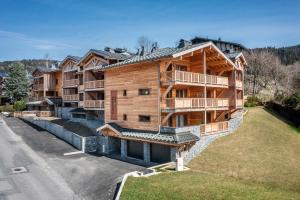 an aerial view of a large wooden building at Apartment Colibri Les Gets - by EMERALD STAY in Les Gets