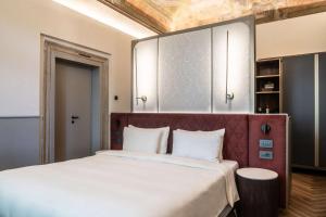 een slaapkamer met een groot bed met een rood hoofdeinde bij Radisson Collection Hotel, Palazzo Nani Venice in Venetië