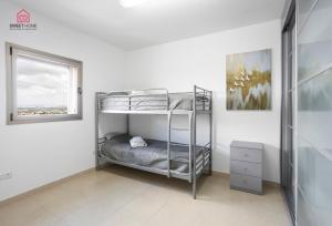 a bedroom with bunk beds in a white room at Luxury apartments' in Netanya in Netanya