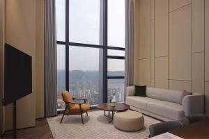a living room with a couch and a table at Conrad Chongqing in Chongqing