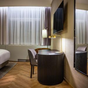 a hotel room with a desk and a bed at DoubleTree By Hilton Brussels City in Brussels
