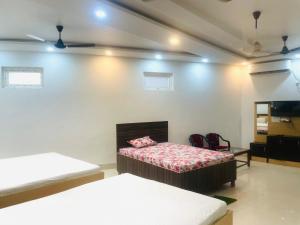 A bed or beds in a room at narayan resort and marriage hall