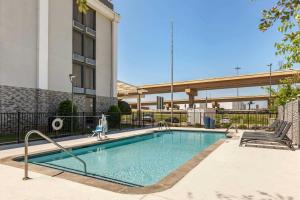 a swimming pool in front of a building at Comfort Inn Dallas North Love Field Airport in Dallas