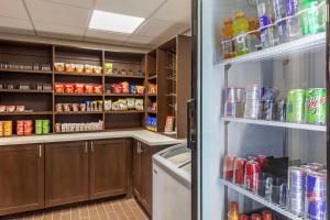 a kitchen with a pantry with food and drinks at Comfort Inn Dallas North Love Field Airport in Dallas