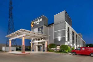 a building with a car parked in front of it at Comfort Inn Dallas North Love Field Airport in Dallas
