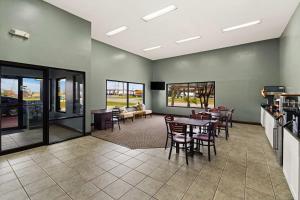 a living room with a table and chairs at SureStay by Best Western Gulfport in Gulfport